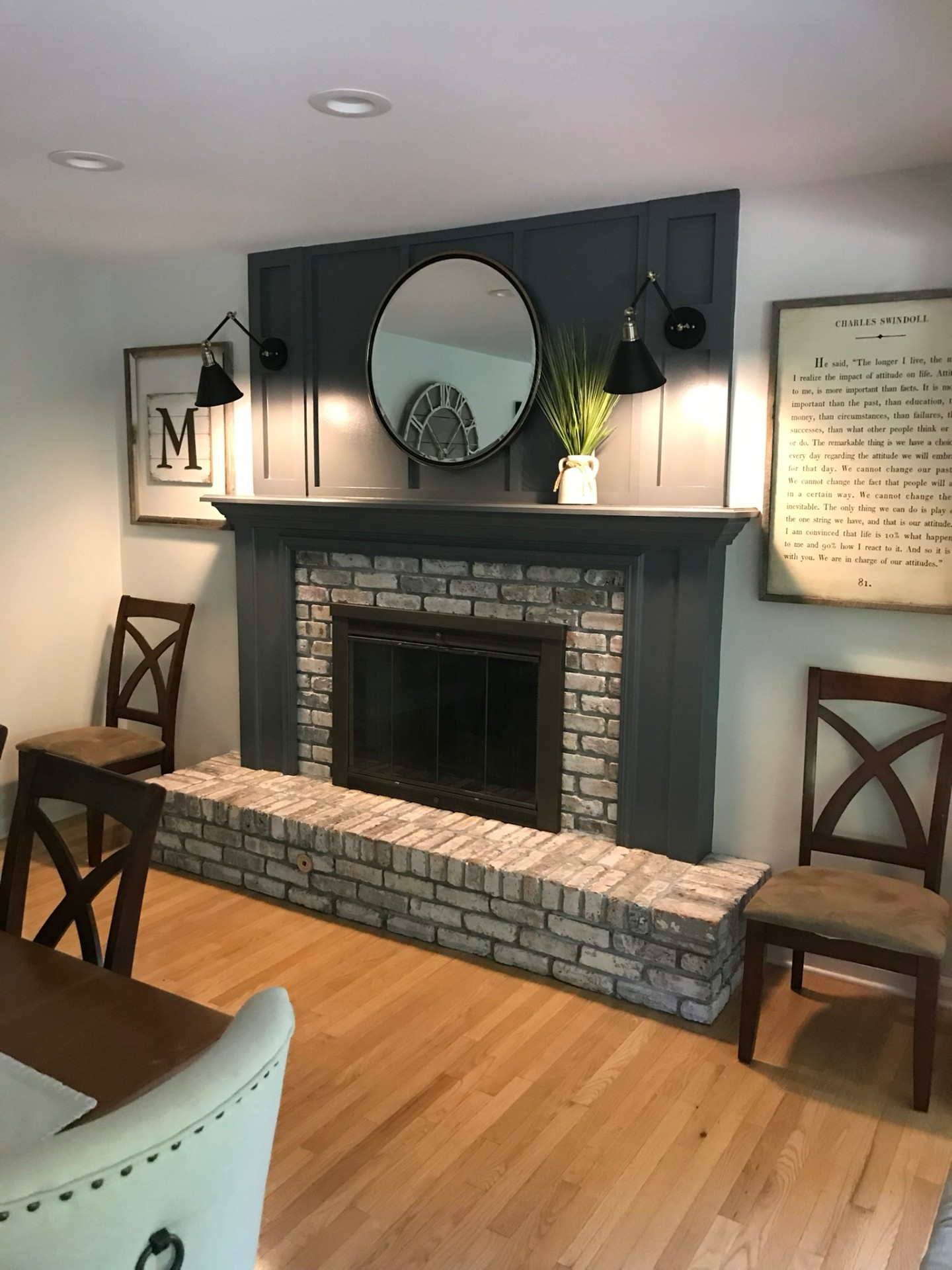 Living room remodel with custom stone fireplace surround, built-in millwork, and hardwood floors