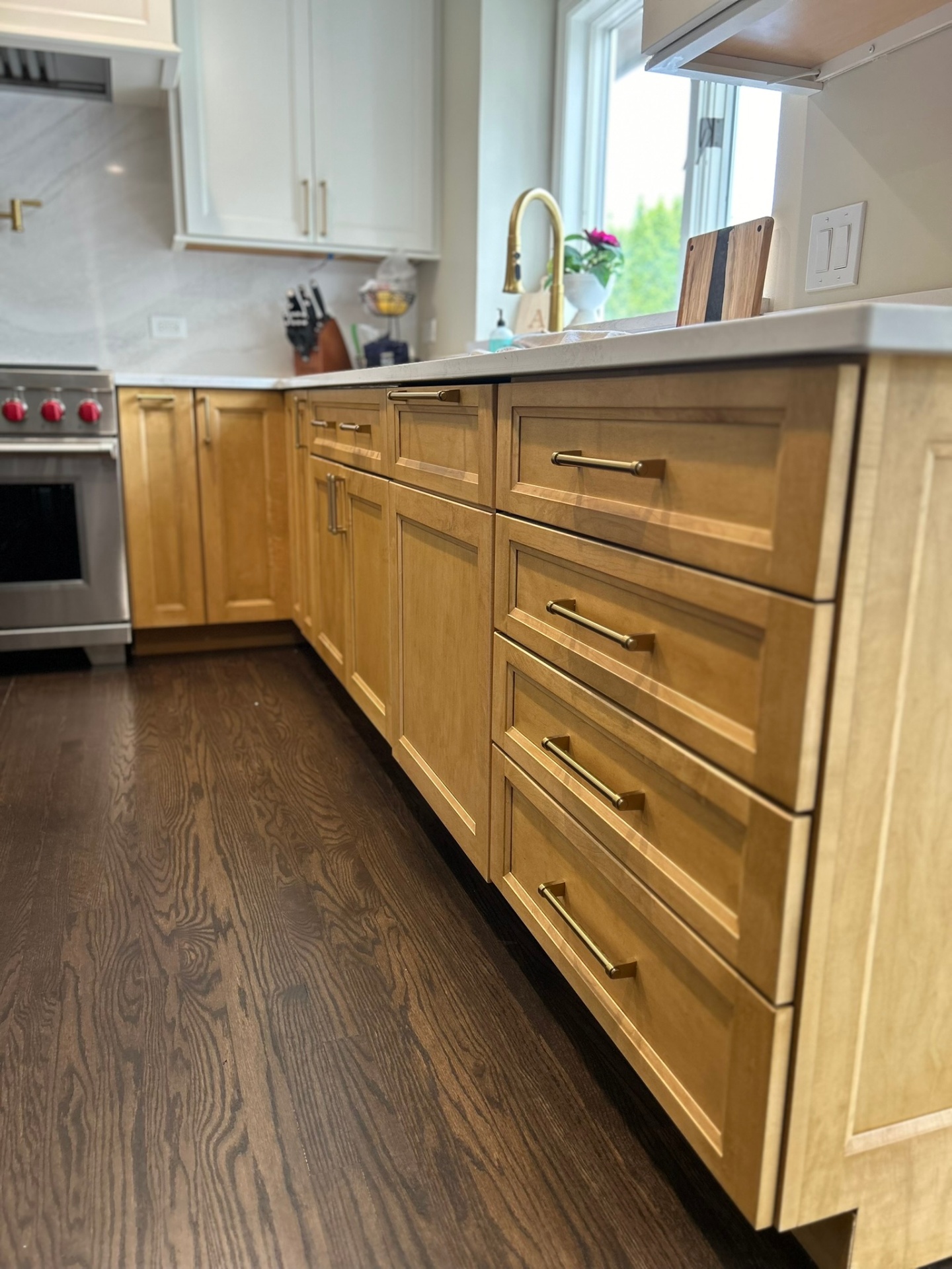 Custom maple kitchen remodel with quartz countertops, tile backsplash, and island seating by Streamline Renovates